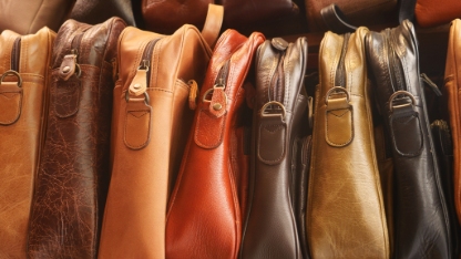 Close up of leather handmade bags on a wall for sale