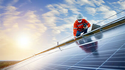 Engineer working use a power check machine on checking power of solar panels on the roof, Solar energy technology concept