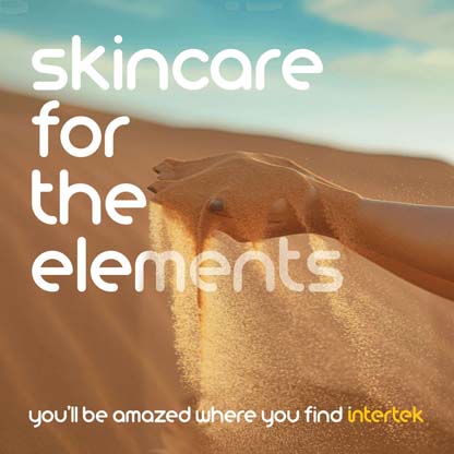 A woman's hand with sand falling from it against the backdrop of a dune