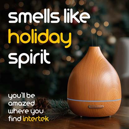 A plug-in air freshener sitting next to a Christmas tree