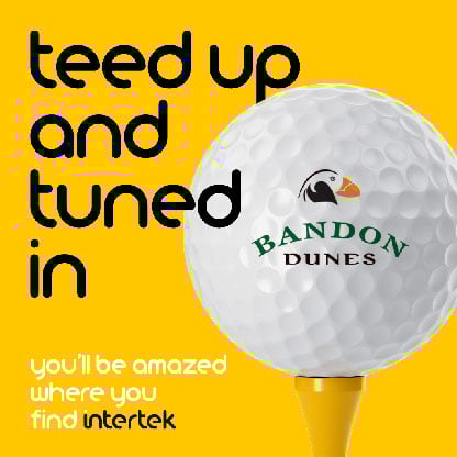 A golf ball with the Bandon Dunes logo sitting on a tee
