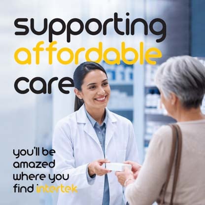 A pharmacist smiling while interacting with a customer